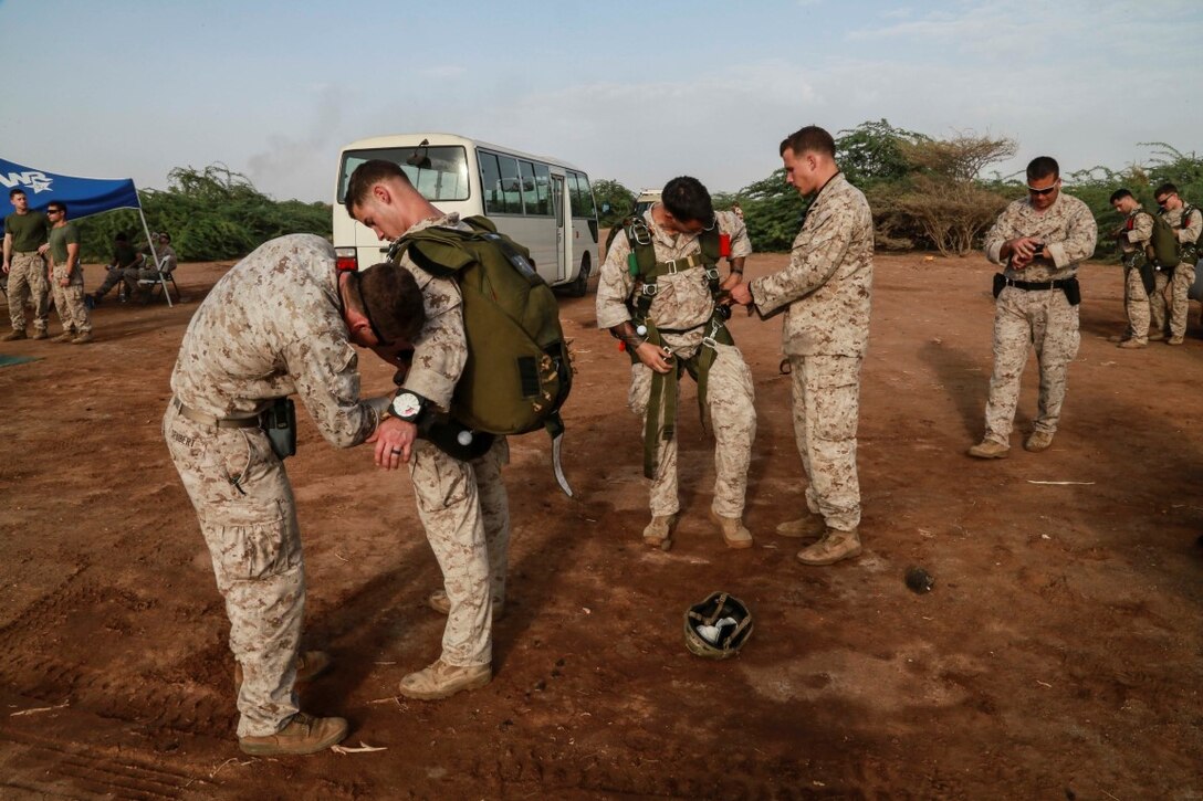 CAMP LEMONNIER, Djibouti (Sept. 15, 2015) U.S. Marines with the 15th Marine Expeditionary Unit’s Force Reconnaissance Detachment inspect each other’s parachutes prior to jumping out of a French SA 330 Puma helicopter. Elements of the 15th MEU are conducting bilateral training with the French 5th Overseas Combined Arms Regiment (RIAOM) and other French forces in Djibouti in order to improve interoperability between the MEU and the French military. (U.S. Marine Corps photo by Sgt. Steve H. Lopez/Released)