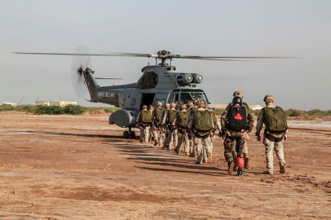 CAMP LEMONNIER, Djibouti (Sept. 15, 2015) U.S. Marines with the 15th Marine Expeditionary Unit’s Force Reconnaissance Detachment and French paratroopers load onto a French SA 330 Puma. Elements of the 15th MEU are conducting bilateral training with the French 5th Overseas Combined Arms Regiment (RIAOM) and other French forces in Djibouti in order to improve interoperability between the MEU and the French military. (U.S. Marine Corps photo by Sgt. Steve H. Lopez/Released)