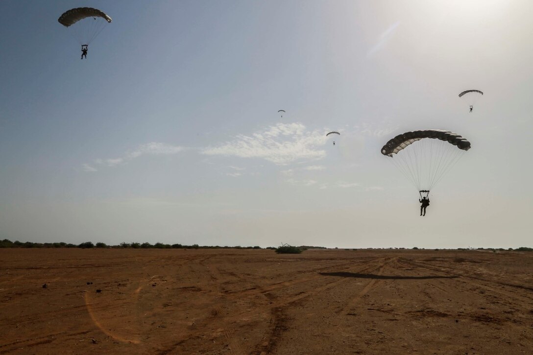 CAMP LEMONNIER, Djibouti (Sept. 15, 2015) U.S. Marines with the 15th Marine Expeditionary Unit’s Force Reconnaissance Detachment and French paratroopers parachute out of a French SA 330 Puma helicopter. Elements of the 15th MEU are conducting bilateral training with the French 5th Overseas Combined Arms Regiment (RIAOM) and other French forces in Djibouti in order to improve interoperability between the MEU and the French military. (U.S. Marine Corps photo by Sgt. Steve H. Lopez/Released)