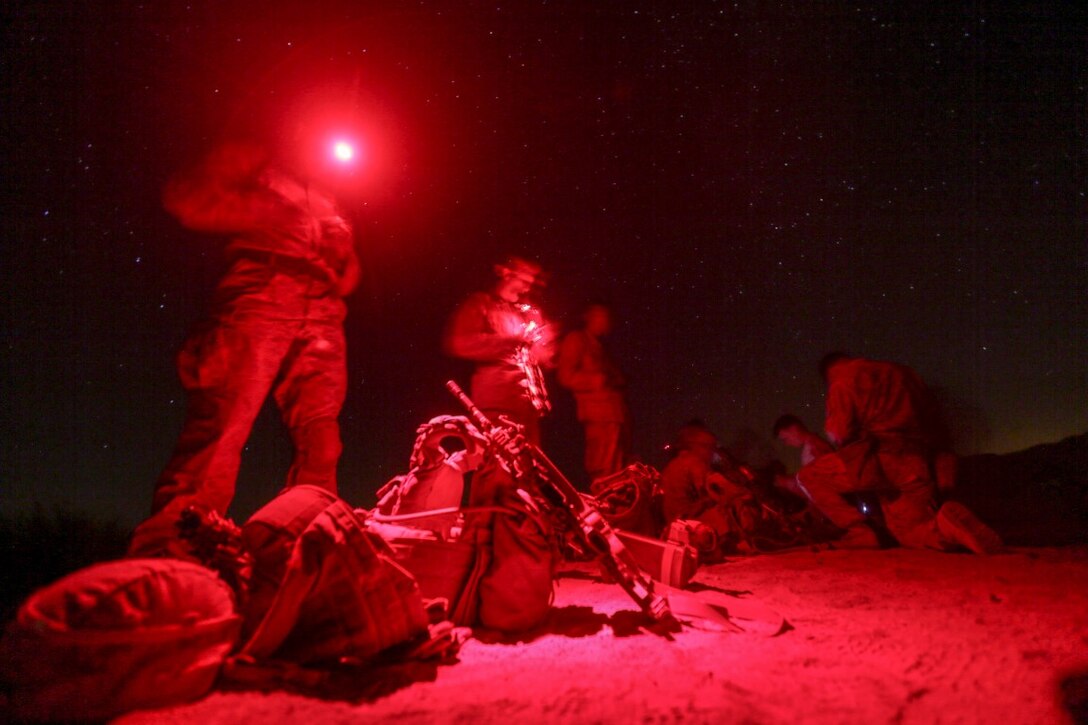 SOUTHWEST ASIA (Sept. 17, 2015) U.S. Marines with India Company, Battalion Landing Team 3rd Battalion, 1st Marine Regiment, 15th Marine Expeditionary Unit, prepare their gear during a bi-lateral training exercise. The 15th MEU, embarked aboard the ships of the Essex Amphibious Ready Group, is a forward-deployed, flexible sea-based Marine air-ground task force capable of engaging with regional partners and maintaining regional security. (U.S. Marine Corps photo by Sgt. Jamean Berry/Released)