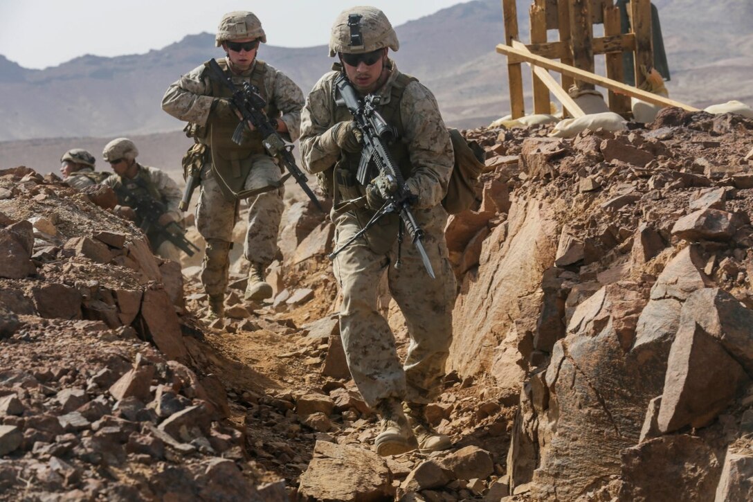 SOUTHWEST ASIA (Sept. 17, 2015) U.S. Marine Lance Cpl. Cody Baker, center, and Lance Cpl. Jerimiah Lance clear a trench during a bi-lateral training exercise. Baker and Lance are riflemen with India Company, Battalion Landing Team 3rd Battalion, 1st Marine Regiment, 15th Marine Expeditionary Unit. The 15th MEU, embarked aboard the ships of the Essex Amphibious Ready Group, is a forward-deployed, flexible sea-based Marine air-ground task force capable of engaging with regional partners and maintaining regional security. (U.S. Marine Corps photo by Sgt. Jamean Berry/Released)
