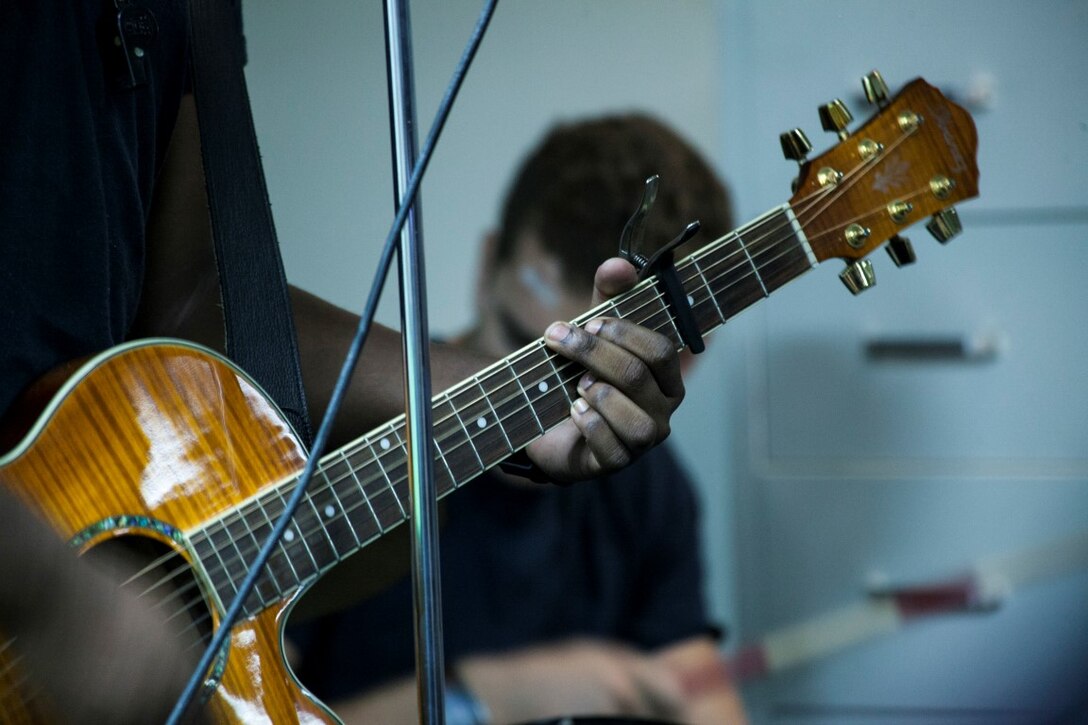 ARABIAN GULF (Sept. 20, 2015) U.S. Sailors with the Essex Amphibious Ready Group perform a worship song during a contemporary church service aboard the amphibious assault ship USS Essex (LHD 2). The 15th Marine Expeditionary Unit is embarked aboard the Essex Amphibious Ready Group and deployed to maintain regional security in the U.S. 5th Fleet area of operations. (U.S. Marine Corps photo by Cpl. Elize McKelvey/Released)