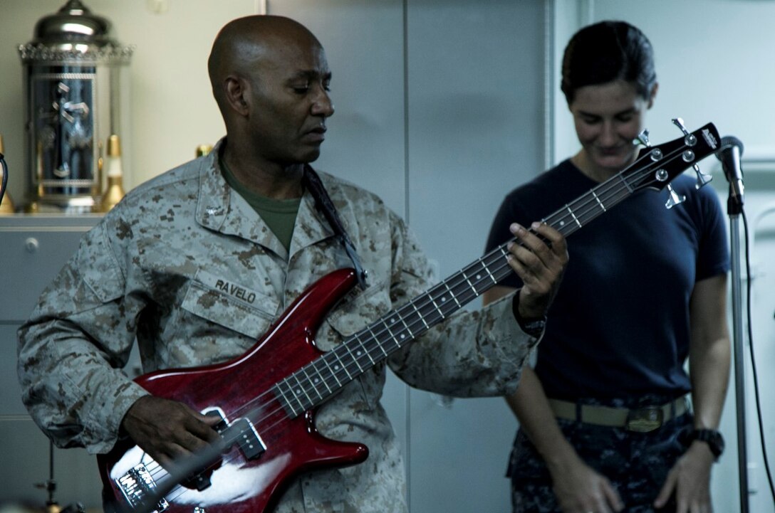 ARABIAN GULF (Sept. 20, 2015) U.S. Sailors with the 15th Marine Expeditionary Unit and Essex Amphibious Ready Group perform a worship song during a contemporary church service aboard the amphibious assault ship USS Essex (LHD 2). The 15th MEU is embarked aboard the Essex Amphibious Ready Group and deployed to maintain regional security in the U.S. 5th Fleet area of operations. (U.S. Marine Corps photo by Cpl. Elize McKelvey/Released)