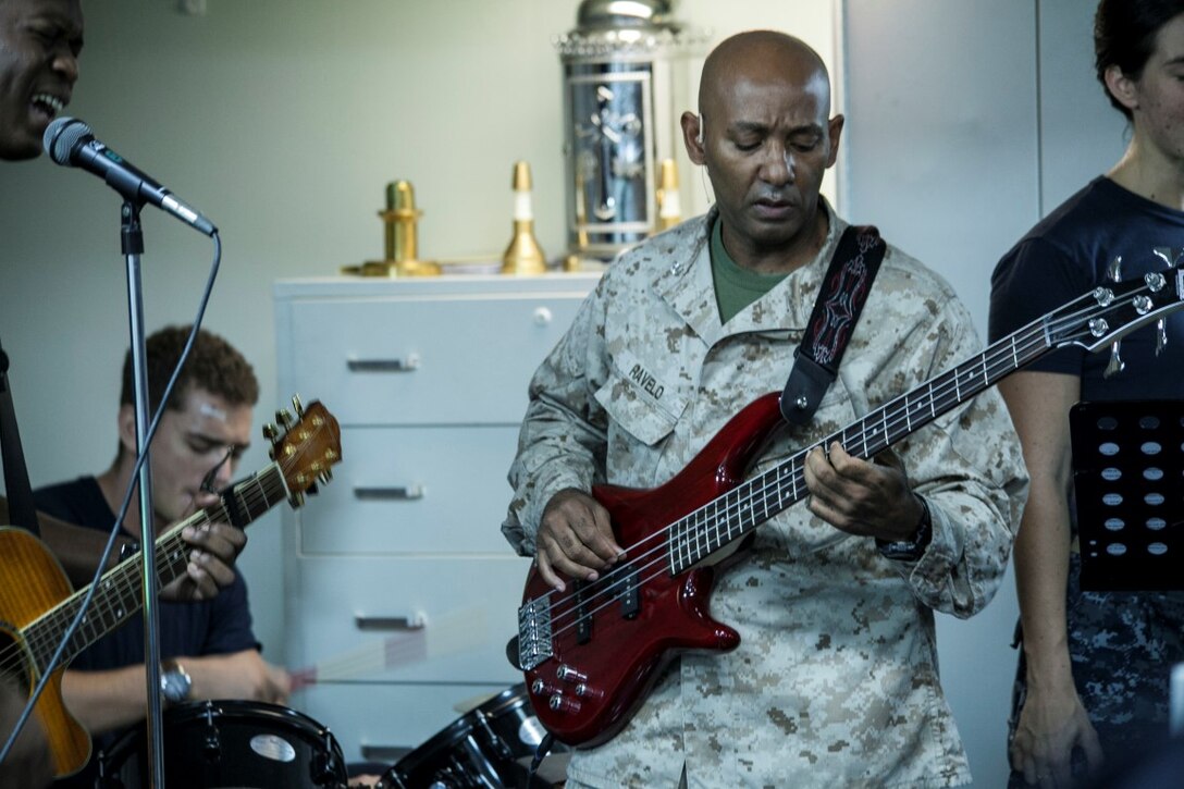 ARABIAN GULF (Sept. 20, 2015) U.S. Sailors with the 15th Marine Expeditionary Unit and Essex Amphibious Ready Group perform a worship song  during a contemporary church service aboard the amphibious assault ship USS Essex (LHD 2). The 15th MEU is embarked aboard the Essex Amphibious Ready Group and deployed to maintain regional security in the U.S. 5th Fleet area of operations. (U.S. Marine Corps photo by Cpl. Elize McKelvey/Released)