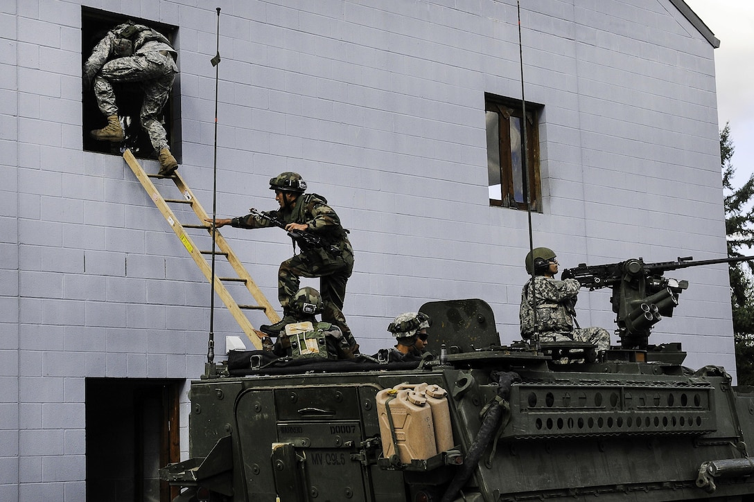 U.S. and Indian soldiers infiltrate the second floor of a building while they conduct company movement procedures during the exercise Yudh Abhyas 2015 on Joint Base Lewis-McChord, Wash., Sept. 21, 2015. U.S. Army photo by Sgt. Daniel Schroeder