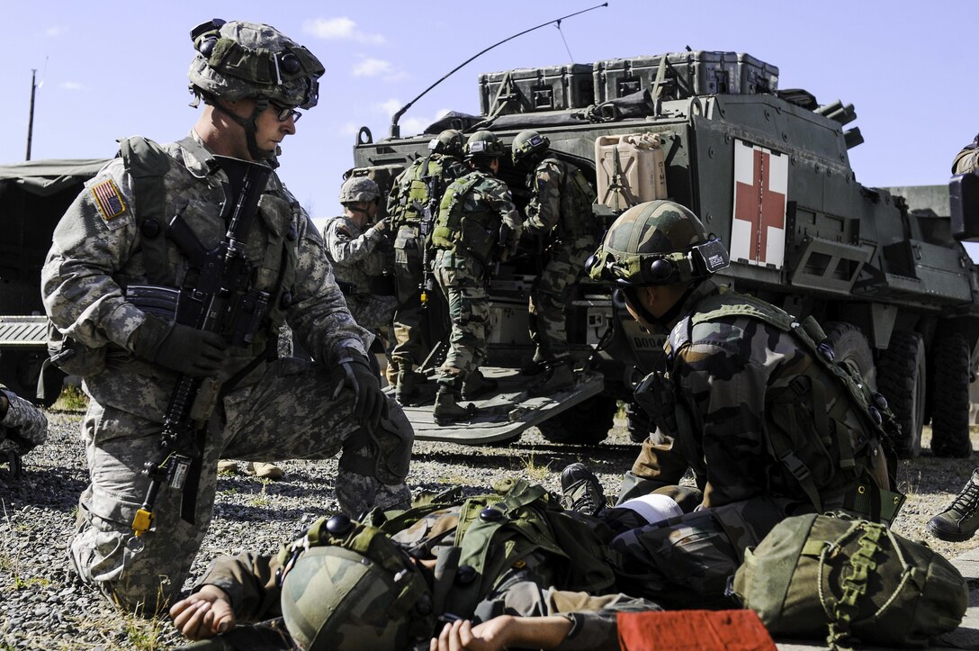 U.S. and Indian soldiers provide medical aid to simulated casualties before loading them on a medical Stryker combat vehicle during the exercise Yudh Abhyas 2015 on Joint Base Lewis-McChord, Wash., Sept. 21, 2015. U.S. Army photo by Sgt. Daniel Schroeder