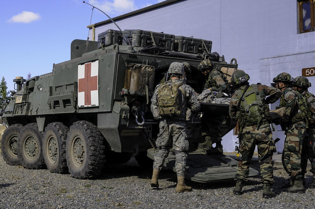 U.S. and Indian soldiers load simulated casualties into a medical Stryker combat vehicle during the exercise Yudh Abhyas 2015 on Joint Base Lewis-McChord, Wash., Sept. 21, 2015. U.S. Army photo by Sgt. Daniel Schroeder