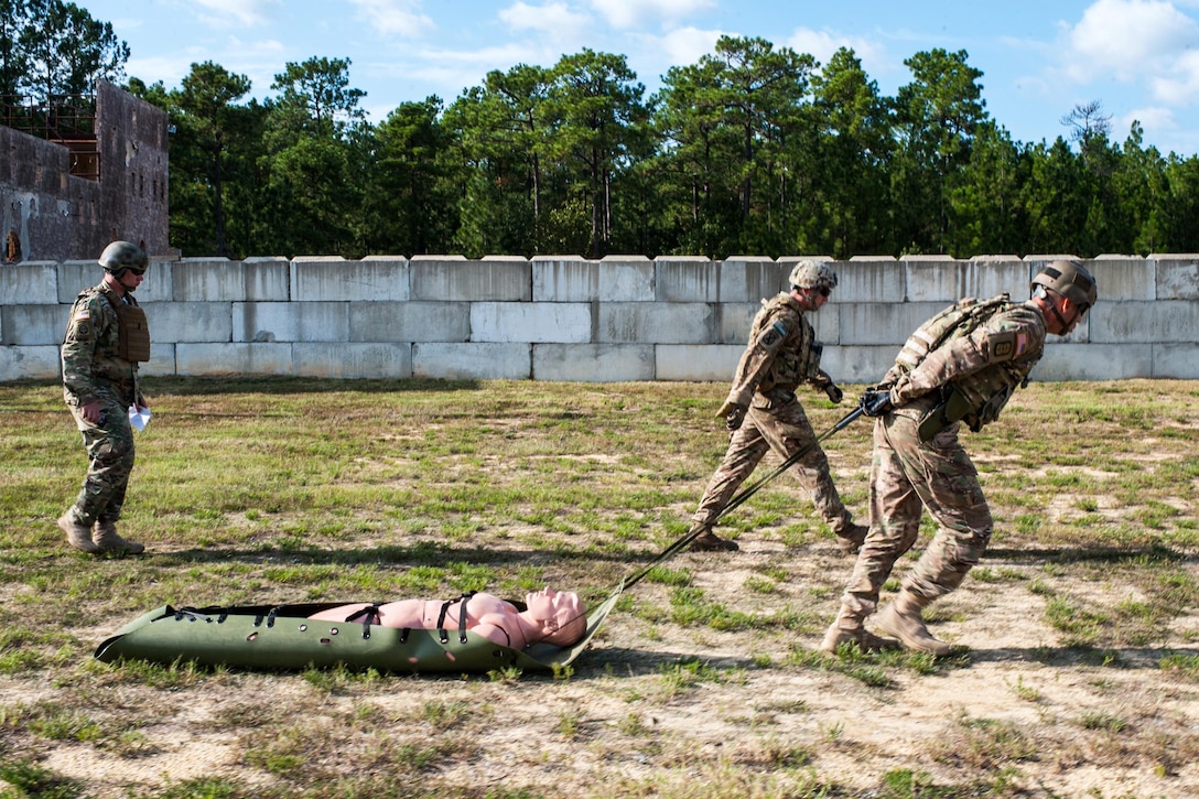Army Master Sgt. Russell Moore pulls a 175-pound mannequin during the stress-fire event of the U.S. Army Forces Command Weapons Marksmanship Competition on Fort Bragg, N.C., Sept. 22, 2015. The stress-fire event allows contestants to demonstrate their marksmanship skills in difficult conditions. U.S. Army photo by Timothy L. Hale