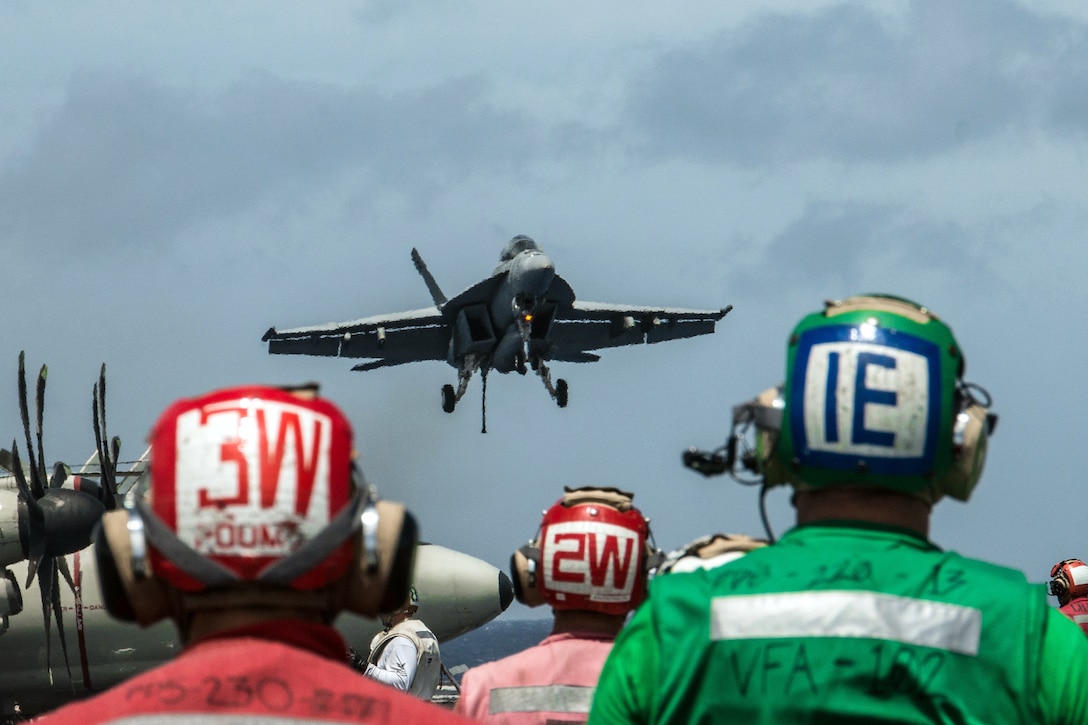 U.S. sailors watch as an F/A-18F Super Hornet comes in for a landing on the flight deck of the USS Ronald Reagan in the Pacific Ocean, Sept. 23, 2015. The Ronald Reagan and its embarked air wing, Carrier Air Wing 5, provide a combat-ready force to protect and defend the collective maritime interests of allies and partners in the Indo-Asia-Pacific region. U.S. Navy photo by Petty Officer 3rd Class Nathan Burke