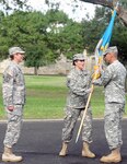 Col. Dustin Schultz (center), commander of the newly established 505th Military Intelligence Brigade (Theater), passes the unit colors to 505th MIB Command Sgt. Maj. Richard Hall (right) during a unit activation ceremony on Fort Sam Houston Friday. Presiding over the ceremony was Brig. Gen. Christie Nixon (left), commanding general of the U.S. Army Military Intelligence Readiness Command.