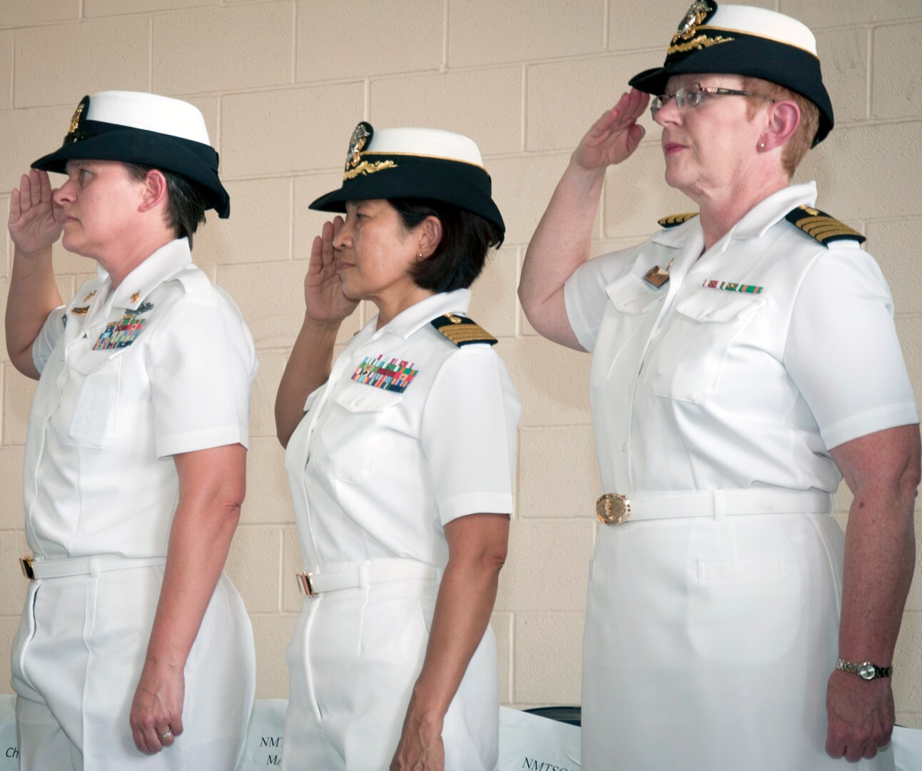 (From left) Command Master Chief Melissa Foster, Navy  Medicine Training Support Center; Capt. Cora Bayle Cox NMTSC executive officer; and Capt. Denise Smith, NMTSC commanding officer, salute during the singing of the national anthem at a 9/11 commemoration ceremony at San Antonio Fire Station 1.