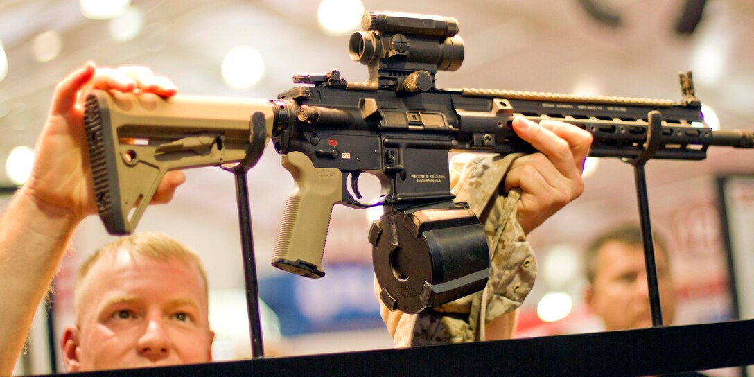 Sgt. Joe Morrison, Headquarters Co., views a weapon at the Magpul Industries booth out of Erie, Colo. during the 35th Anniversary edition of Modern Day Marine Military Exposition aboard MCBQ, Sept. 22. Morrison is a native of Grand View, Idaho.
