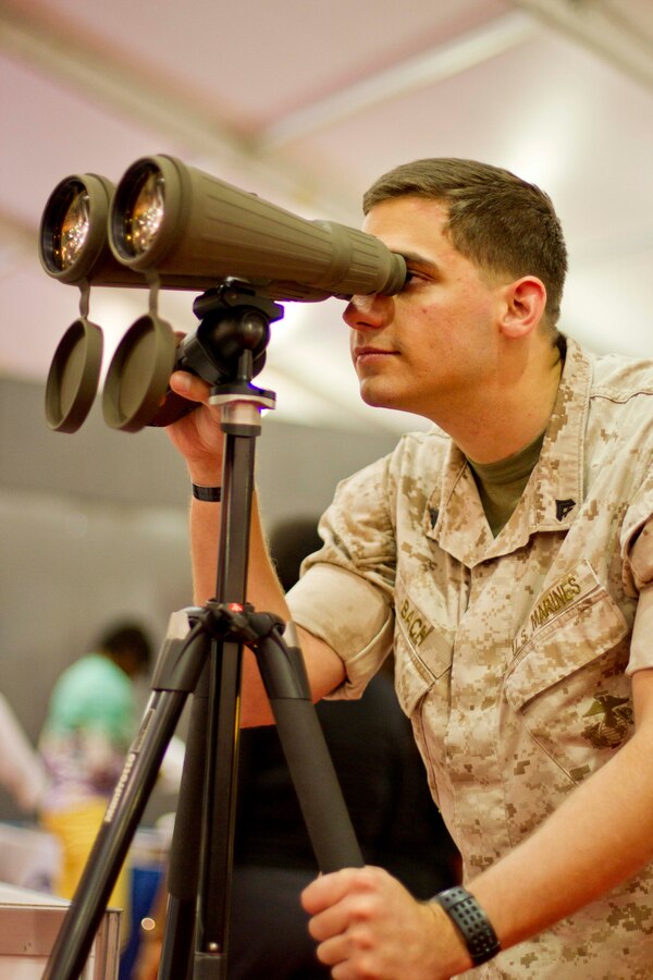 Cpl. Daniel Bach, extractor in Chemical Biological Incident Response Force, tests a pair of binoculars during the 35th Anniversary edition of Modern Day Marine Military Exposition aboard MCBQ, Sept. 2