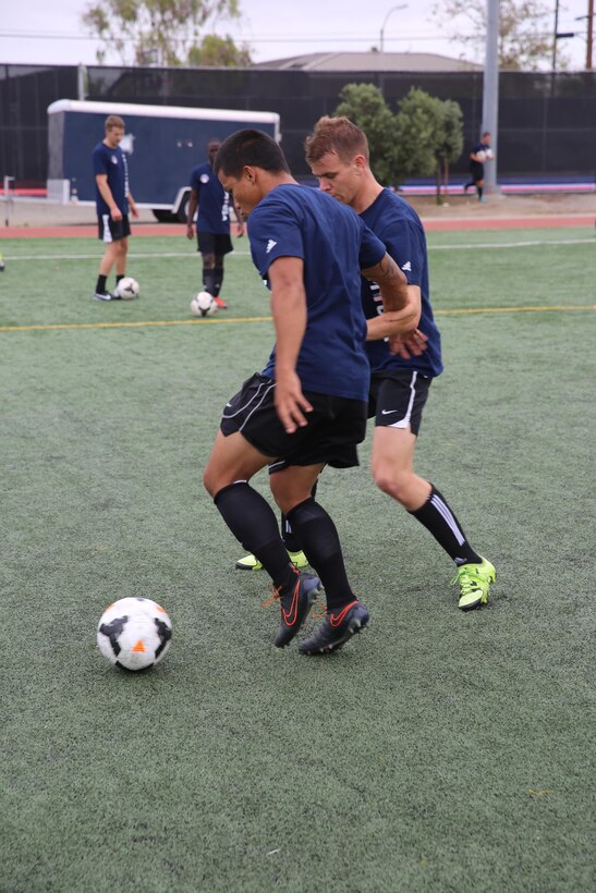 Service members with the U.S. Men’s Armed Forces Soccer Team go head to head during a practice session aboard Marine Corps Air Station Miramar, Calif., Sept. 22. The team is scheduled to play in the upcoming World Military Games in South Korea. (U.S. Marine photo by Lance Cpl. Kimberlyn Adams/Released)