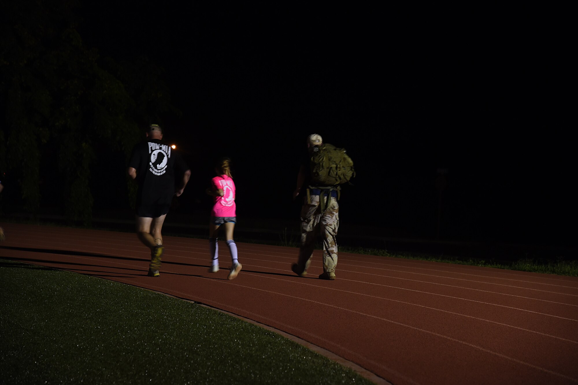 Airmen and family members run during the 24-hour Prisoner of War and Missing In Action remembrance run on Joint Base Pearl Harbor-Hickam, Hawaii, Sept. 17, 2015. The 24 hour POW/MIA remembrance run was organized by the 25th Air Support Operations Squadron as a part of POW/MIA week and National POW/MIA Day. Every year the nation pauses on the third Friday of September to remember the sacrifices and service of prisoners of war. There are 83,344 Americans still unaccounted-for across the Defense Department. (U.S. Air Force photo by Tech. Sgt. Aaron Oelrich/Released)   