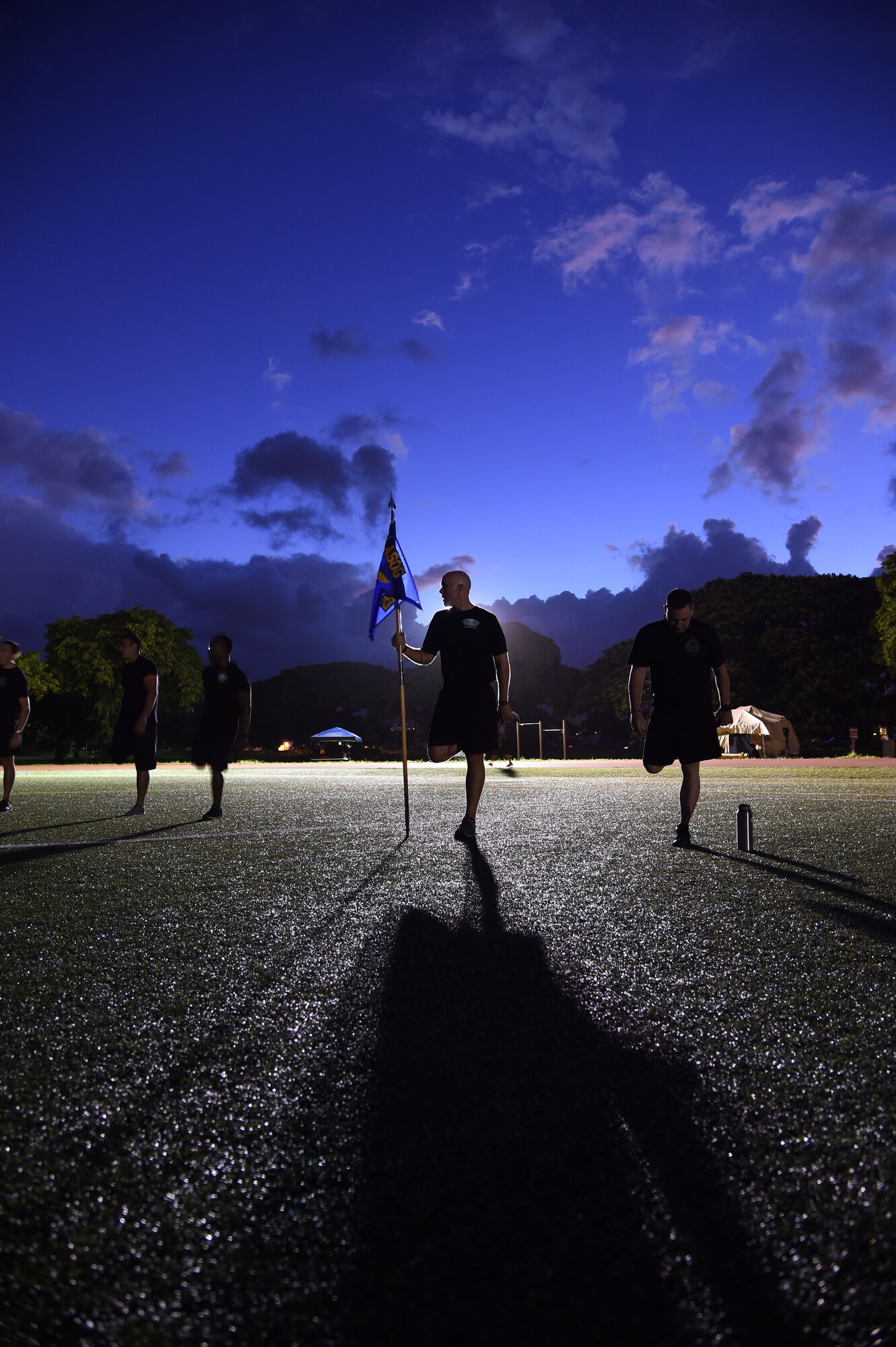 U.S. Air Force Master Sgt. Kurt Ward,  first sergeant from the 25th Air Support Operations Squadron, stretches before a formation run at the end of the 24-hour Prisoner of War and Missing In Action remembrance run on Joint Base Pearl Harbor-Hickam, Hawaii, Sept. 18, 2015. The 24 hour POW/MIA remembrance run was organized by the 25th Air Support Operations Squadron as a part of POW/MIA week and National POW/MIA Day. Every year the nation pauses on the third Friday of September to remember the sacrifices and service of prisoners of war. There are 83,344 Americans still unaccounted-for across the Defense Department. (U.S. Air Force photo by Tech. Sgt. Aaron Oelrich/Released)   