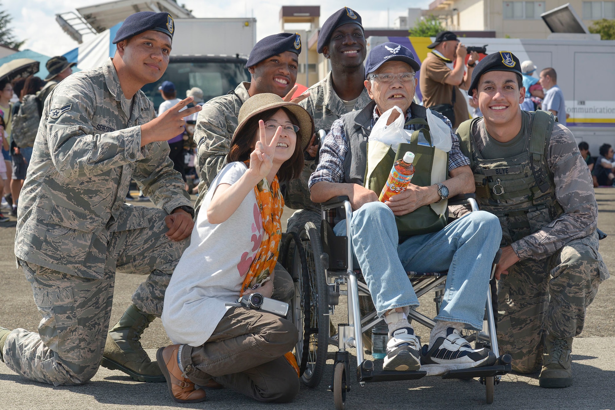 Japanese citizens take a photo with 374 Security Forces Airmen during the 2015 Japanese-American Friendship Festival at Yokota Air Base, Japan, Sept. 20, 2015. The annual festival allows off-base community members to get a first-hand look at US and Japan military capabilities. (U.S. Air Force photo by Staff Sgt. Cody H. Ramirez/Released)