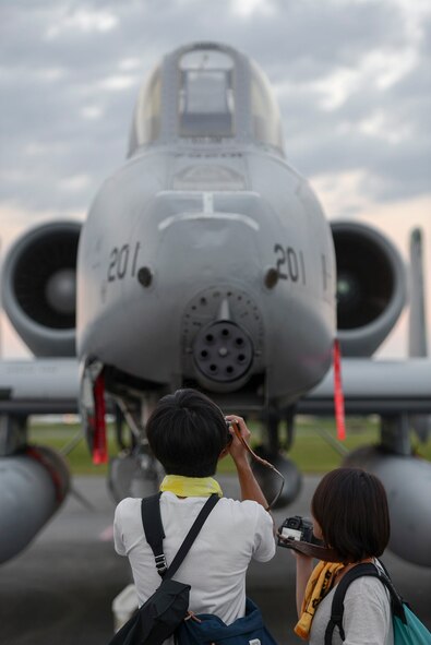 A man takes a photo of an A-10 Warthog during the 2015 Japanese-American Friendship Festival at Yokota Air Base, Japan, Sept. 20, 2015. The Warthog was one of 28 aircraft on display during the annual festival. (U.S. Air Force photo by Staff Sgt. Cody H. Ramirez/Released)