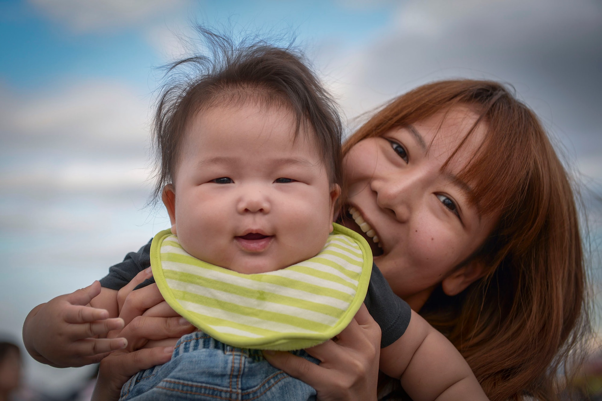 A woman holds her baby during the 2015 Japanese-American Friendship Festival at Yokota Air Base, Japan, Sept. 20, 2015. More than 185,000 people attended the annual festival. (U.S. Air Force photo by Staff Sgt. Cody H. Ramirez/Released)