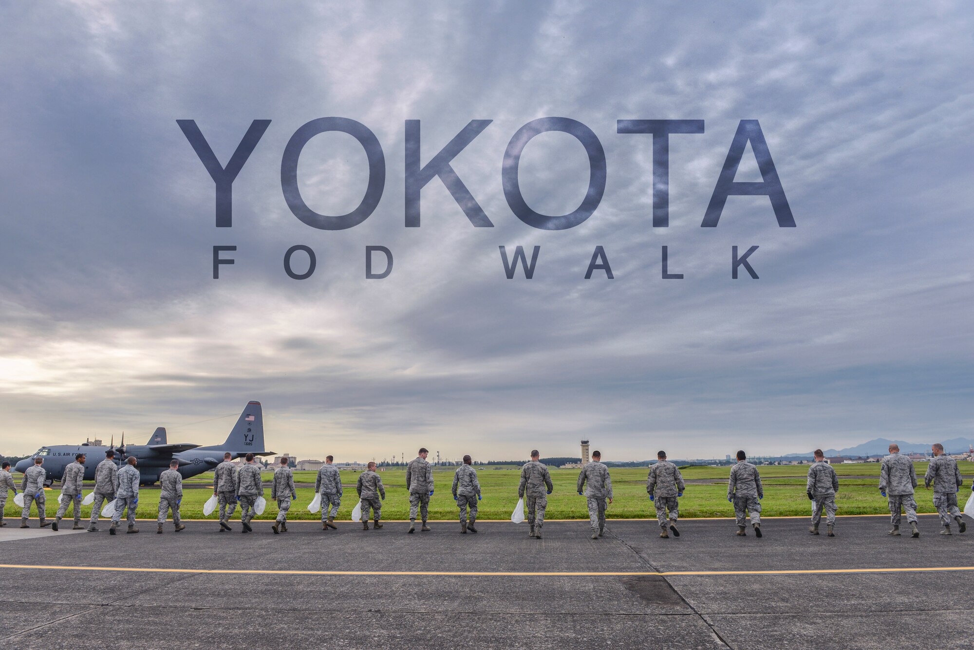 Airmen perform a foreign object debris walk Sept. 21, 2015, at Yokota Air Base, Japan. FOD creates safety hazards and can ultimately impact safe operations by damaging aircraft. The FOD walk helps to clear the flightline of trash and debris before it can cause damage. (U.S. Air Force photo by Airman 1st Class Delano Scott/Released)