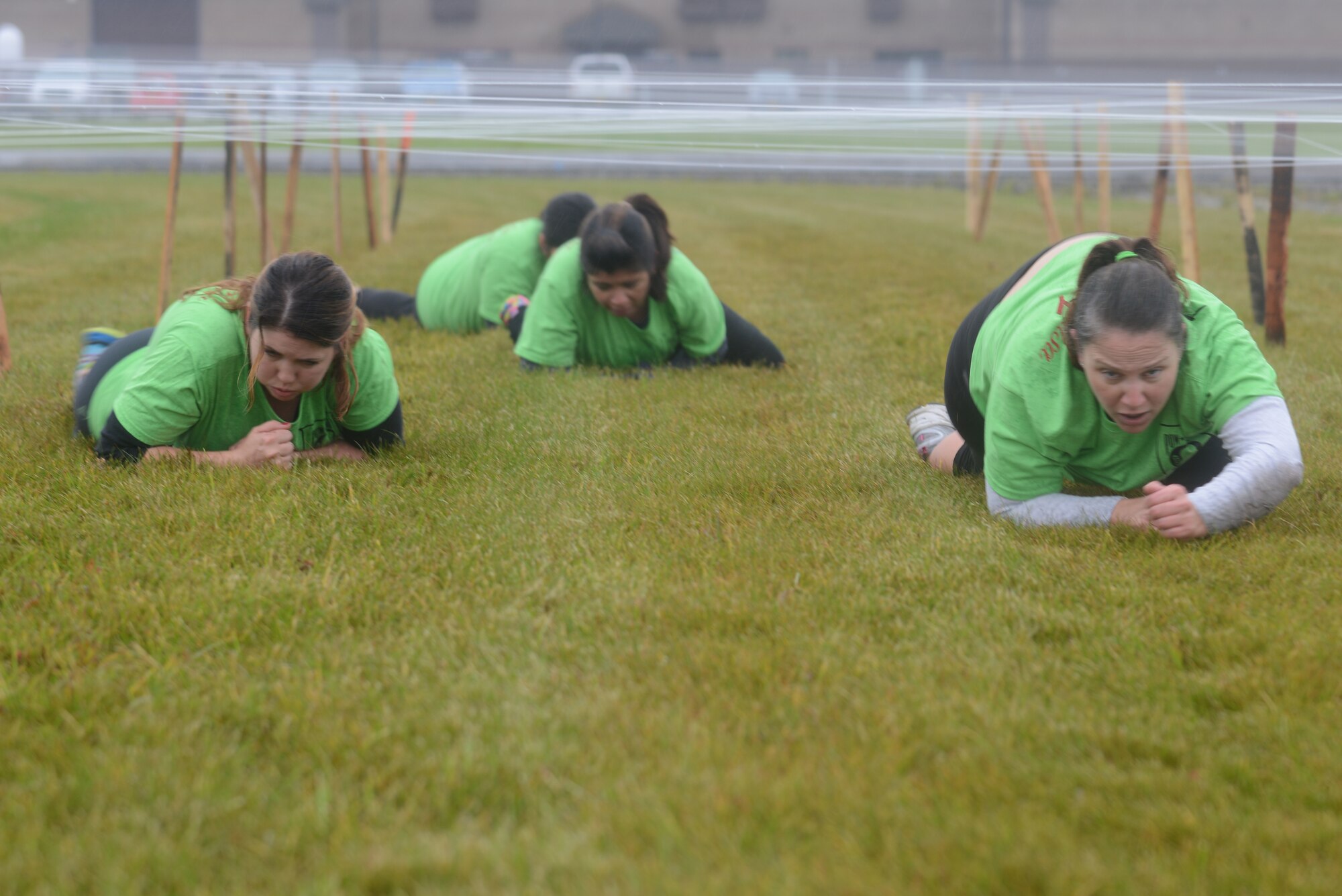 Members from “Team Awesome Salsa” low crawl through an obstacle during the POW/MIA Combat Challenge Sept. 16, 2015, at Eielson Air Force Base, Alaska. The challenge gave participants a sense of camaraderie and teamwork while overcoming the stress of each obstacle. (U.S. Air Force photo by Senior Airman Ashley Nicole Taylor/Released)