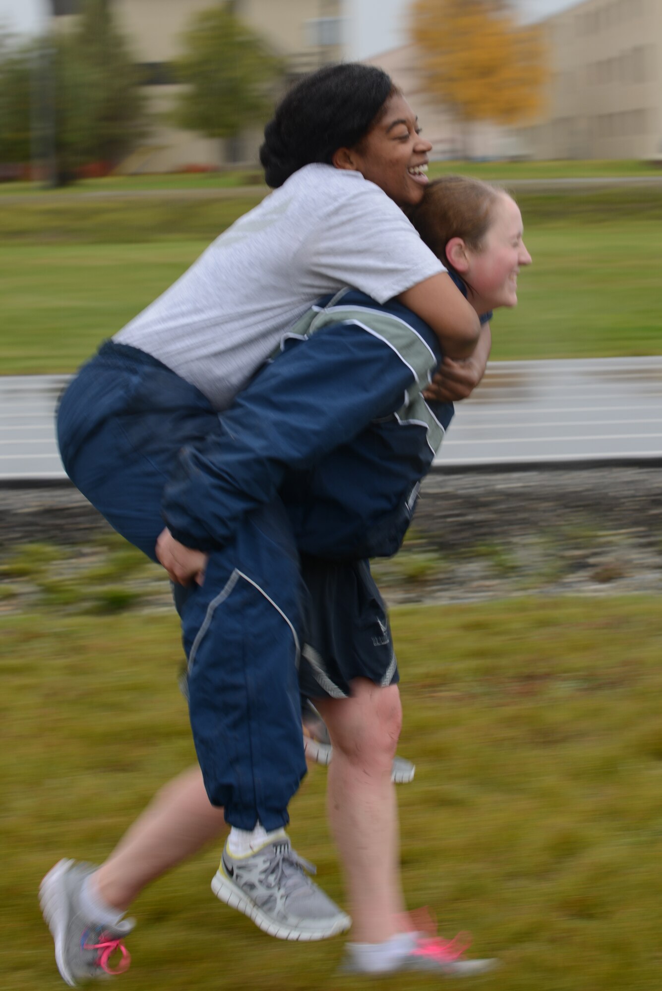 Senior Airman Jenni Jobe, a 354th Maintenance Squadron (MXS) crew chief, carries Senior Airman Brandi Jones, a 354th MXS conventional maintenance crew member, during the POW/MIA Combat Challenge Sept. 16, 2015, at Eielson Air Force Base, Alaska. The obstacles represented the hardships faced by prisoners of war. (U.S. Air Force photo by Senior Airman Ashley Nicole Taylor/Released)