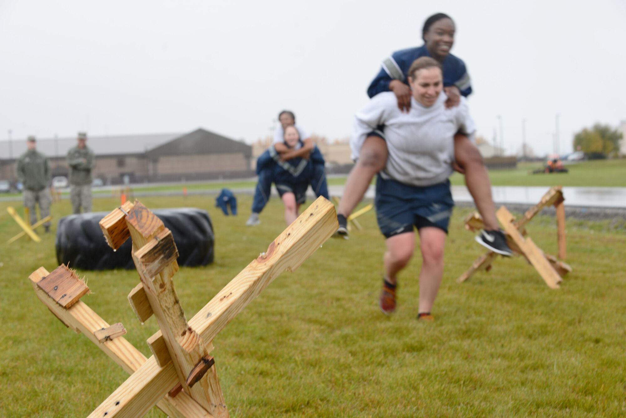 Members with the “AMMO’s All-female Power Team” carry teammates through an obstacle during the POW/MIA Combat Challenge Sept. 16, 2015, at Eielson Air Force Base, Alaska. The challenge required every member to complete each obstacle before moving onto the next one. (U.S. Air Force photo by Senior Airman Ashley Nicole Taylor/Released)