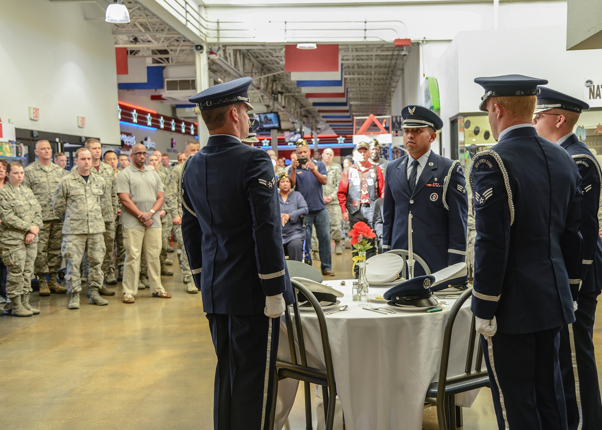The Blue Eagles Honor Guard sets a ceremonial table in honor of servicemembers that are prisoners of war or missing in action in each branch of the military. (U.S. Air Force photo by Rebecca Amber)