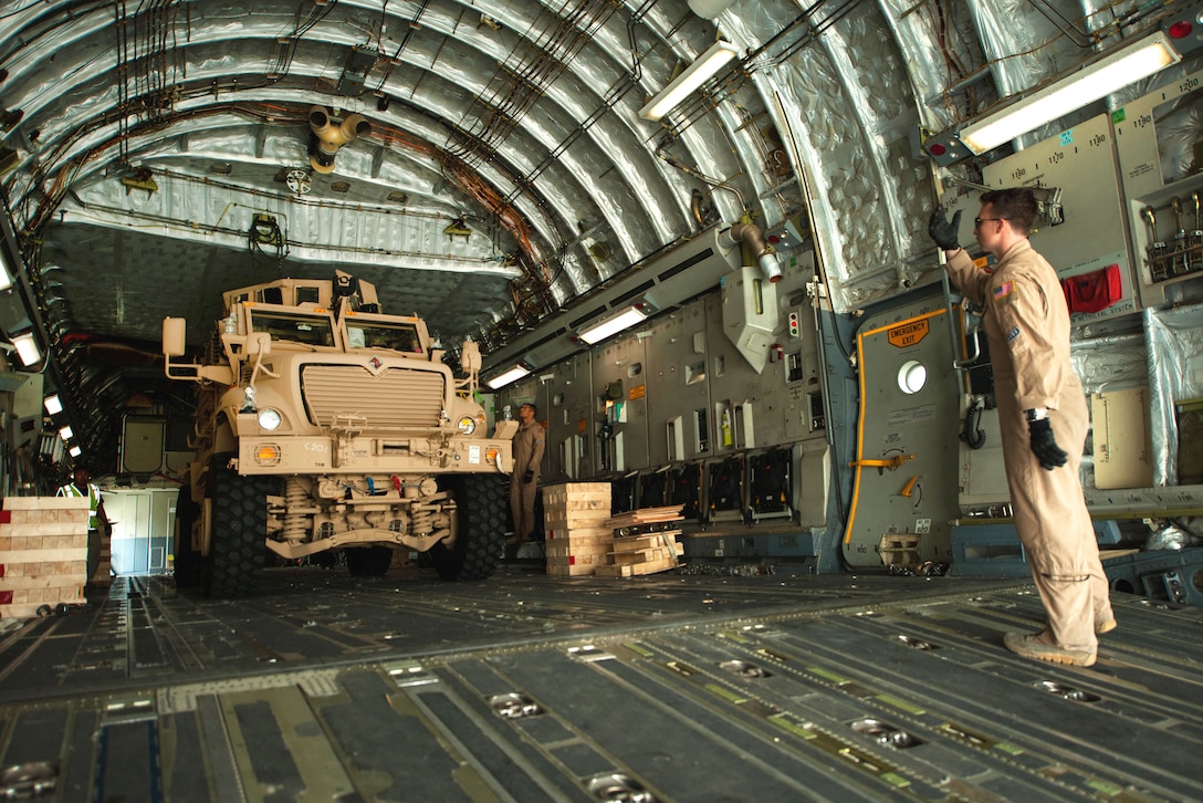 A U.S. Army mine-resistant, ambush-protected vehicle offloads from an Air Force C-17 Globemaster III aircraft on Bagram Airfield, Afghanistan, Sept. 21, 2015. U.S. Air Force photo by Tech. Sgt. Joseph Swafford