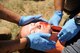 Emergency medical technicians from Joint Base San Antonio- Fort Sam Houston, Texas, assess and treat a patient during a scenario in the EMT Rodeo Sept. 18, 2015, at Melrose Air Force Range, N.M.. Twenty-one teams of elite EMTs from 22 installations across the Air Force convened at Cannon for four days of innovative, high-octane competition Sept. 16-19. Throughout the rodeo teams were required to execute their lifesaving mission under the critical eye of expert evaluators, demonstrating accurate technique and effective implementation. (U.S. Air Force photo by Tech. Sgt. Manuel J. Martinez)