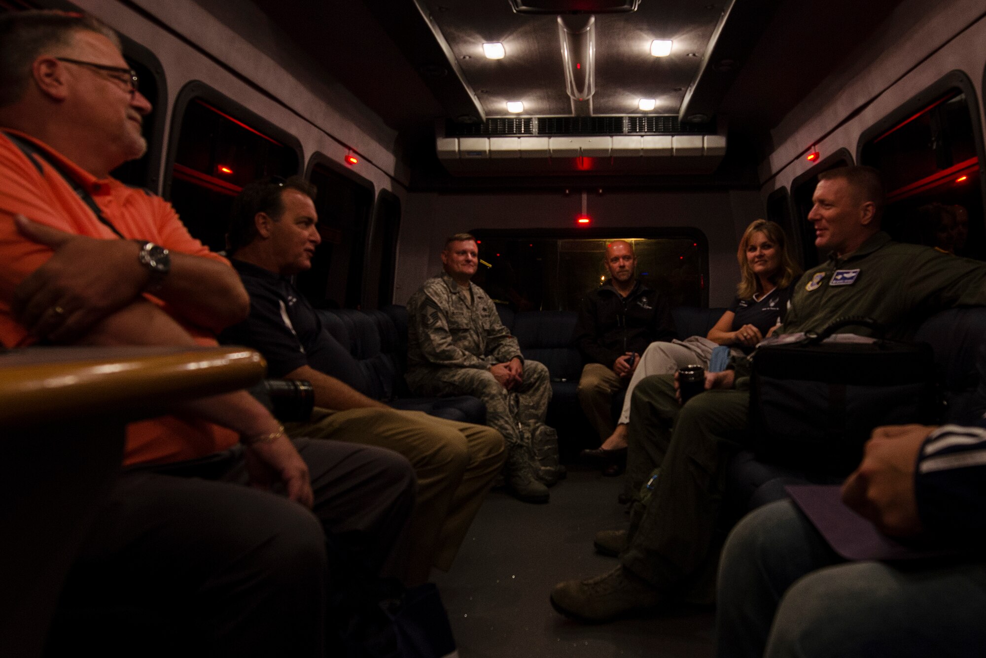 Civic leaders from Team Dover chat with Chief Master Sgt. John Elstrom (left) from the 436th Maintenance Group and 436th Airlift Wing Commander, Col. Michael Grismer, Dover Air Force Base, Del., Sept. 16, 2015, on the bus prior to a C-17 Globemaster III flight to Luke Air Force Base, Ariz., as part of Dover AFB's 2015 community relations tour. CRTs are designed to engage local leaders from the Dover community with unique missions from different military bases outside of the Air Mobility Command. (U.S. Air Force photo by Capt. Bernie Kale)