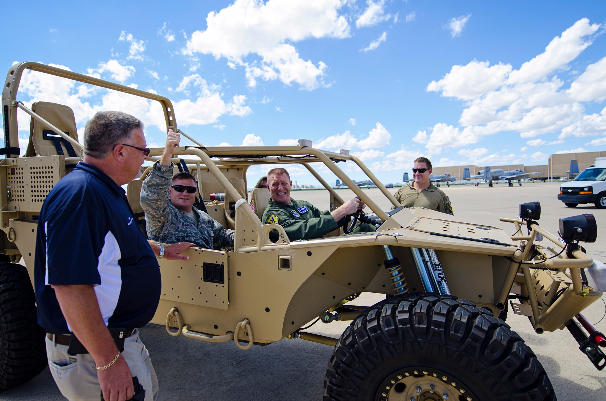 Chief Master Sgt. John Elstrom (left), 436th Maintenance Group, and 436th Airlift Wing Commander ,Col. Michael Grismer, sit inside a new Storm Search and Rescue Tactical Vehicle, Sept. 16, 2015, at Davis Monthan Air Force Base, Ariz., as part of Dover AFB's 2015 community relations tour. CRTs are designed to engage local leaders from the Dover community with unique missions from different military bases outside of the Air Mobility Command. (U.S. Air Force photo by Capt. Bernie Kale)