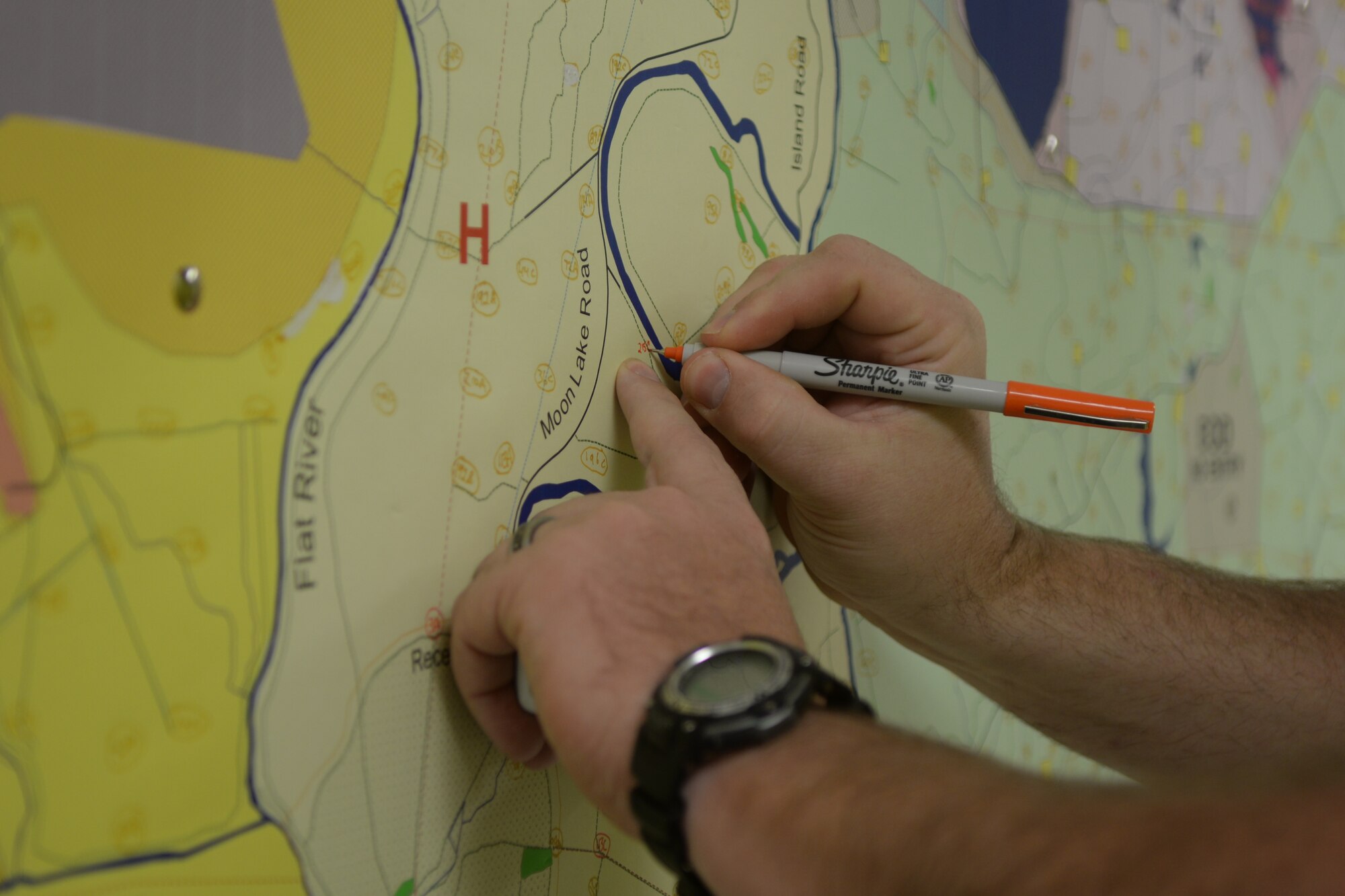 Matthew Stroupe, 2nd Civil Engineer Squadron natural resource manager, marks a map for a hunter during deer stand registration at Barksdale Air Force Base, La., Sept. 15, 2015. On the first day of stand registration, newcomers may register for a hunting location, and people who hunted on base last year can move their stands to new locations. (U.S. Air Force photo/Senior Airman Amanda Morris)