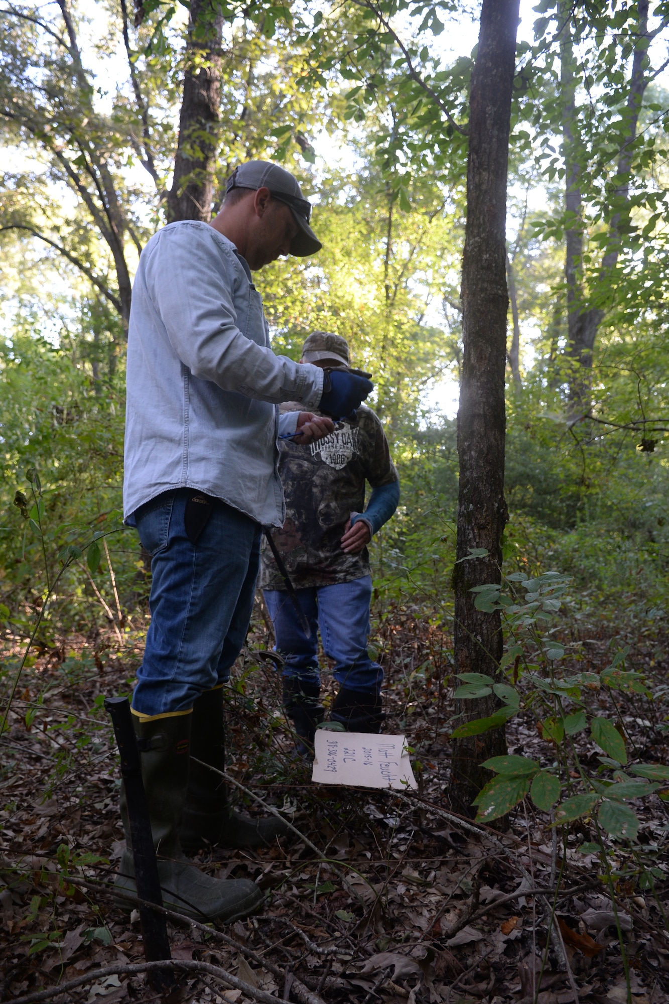 Master Sgt. James Welch, 307th Safety explosives safety manager, and Tech. Sgt. David Bailey, 307th Aircraft Maintenance Squadron B-52 Stratofortress crew chief, prepare tags to mark a location for the upcoming deer hunting season at Barksdale Air Force Base, La., Sept 15, 2015. The hunters must mark their deer stand locations to inform passers-by that the location has been claimed. (U.S. Air Force photo/Senior Airman Amanda Morris)