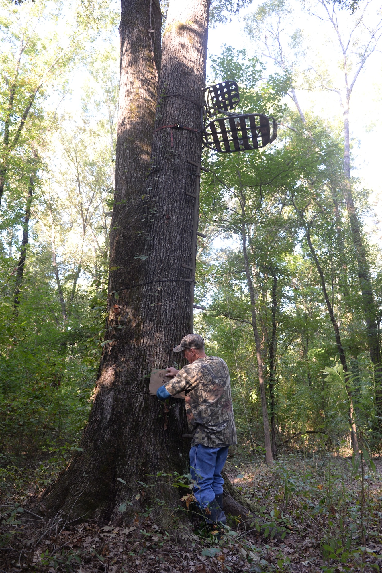 Tech. Sgt. David Bailey, 307th Aircraft Maintenance Squadron B-52 Stratofortress crew chief, places a tag on a tree to claim the location for the upcoming deer hunting season at Barksdale Air Force Base, La., Sept 15, 2015. Hunters have 48 hours to claim their registered locations. If locations are not marked in a timely manner, they may be given to someone else. (U.S. Air Force photo/Senior Airman Amanda Morris)
