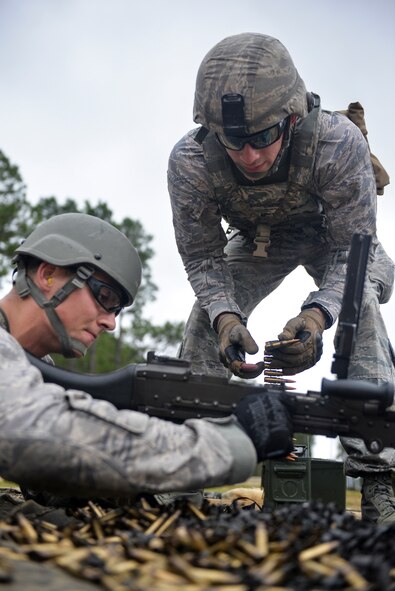 Senior Airmen Aaron Wright and Kenneth Burdick, 2nd Security Forces Squadron installation patrolmen, load an M240 light machine gun in preparation for the 2015 Global Strike Challenge at Fort Polk, La., Sept. 11. Airmen across a number of bases competed in the premier bomber, intercontinental ballistic missile and security forces competition. (U.S. Air Force photo/Airman 1st Class Mozer Da Cunha)