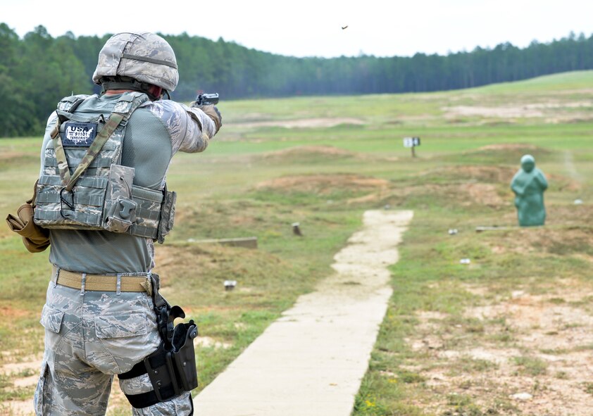 Senior Airman Kenneth Burdick, 2nd Security Forces Squadron installation patrolman, fires an M9 pistol while training for the 2015 Global Strike Challenge at Fort Polk, La., Sept. 11. Reactive targets were used to hone reflexes and reaction time while keeping track of the number of effective target hits. (U.S. Air Force photo/Airman 1st Class Mozer Da Cunha)