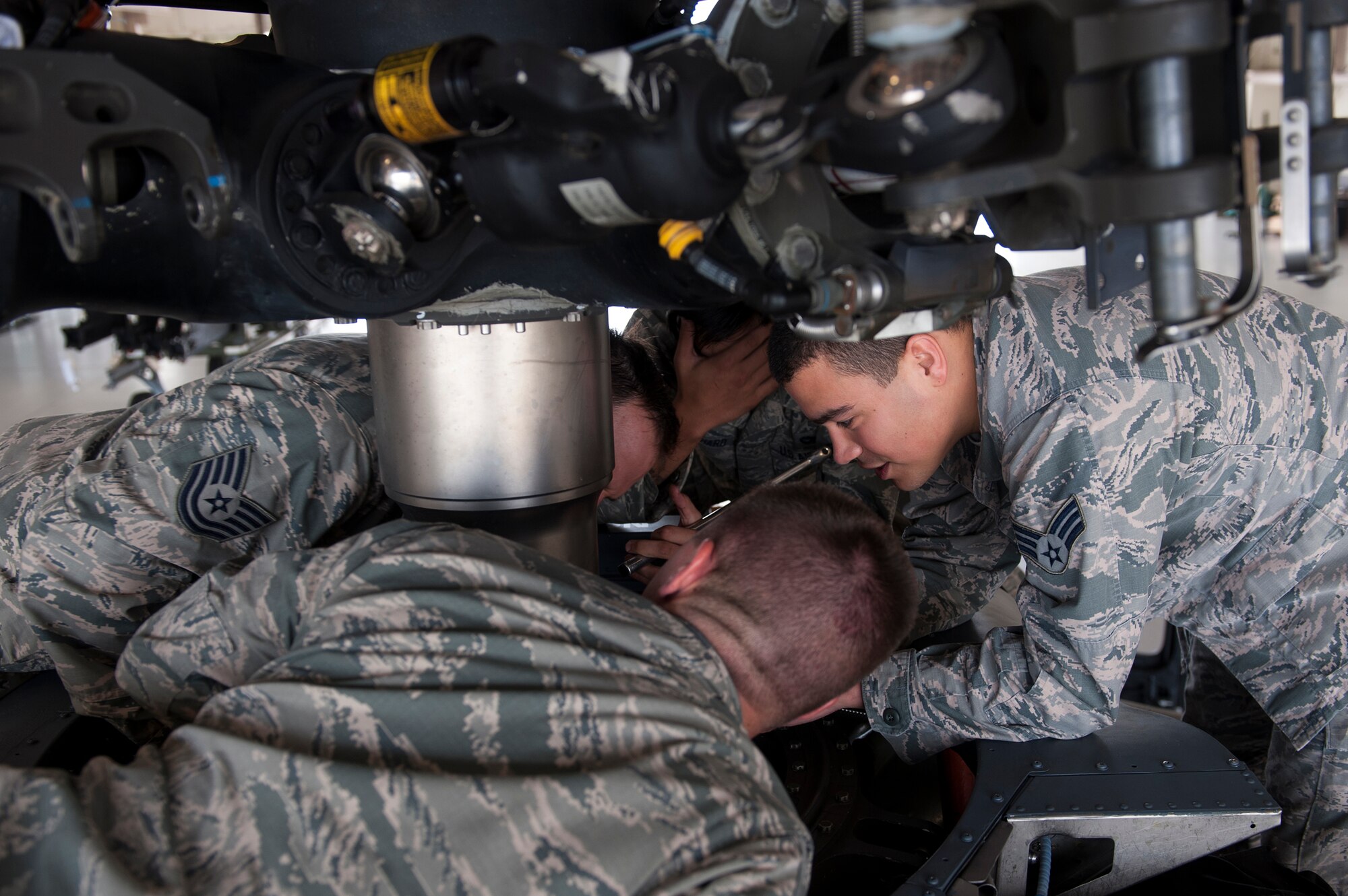 Airmen from the 41st Helicopter Maintenance Unit replace a shaft extension on an HH-60G Pave Hawk Sept. 22, 2015, at Moody Air Force Base, Ga. The primary mission of the 41st HMU is to provide safe and reliable HH-60s that can conduct day or night personnel recovery operations during combat or while providing humanitarian relief. (U.S. Air Force photo by Airman 1st Class Kathleen D. Bryant/Released)
