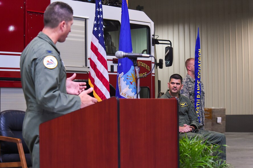 U.S. Air Force Col. Tim Sumja, 23d Fighter Group commander, offers some words of wisdom to Lt. Col. Kevin Beeker, 598th Range Squadron commander, during the 598th RANS activation and assumption of command ceremony Sept 22, 2015, at Avon Park Air Force Range, Fla. The 598th RANS was reactivated as an active-duty squadron that falls under the 23d FG at Moody Air Force Base, Ga. (U.S. Air Force photo by Senior Airman Ceaira Tinsley/Released)