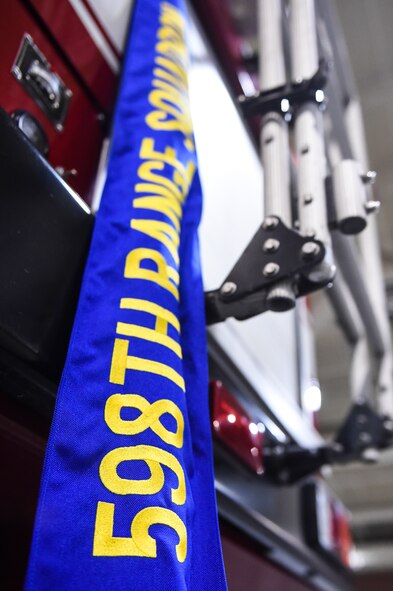 A 598th Range Squadron guideon rests before being uncased and unfurled during the 598th RANS activation and assumption of command ceremony Sept 22, 2015, at Avon Park Air Force Range, Fla. The 598th RANS, formerly known as the 598th Bombardier Squadron, reactivated after being inactive for more than 70 years. (U.S. Air Force photo by Senior Airman Ceaira Tinsley/Released)