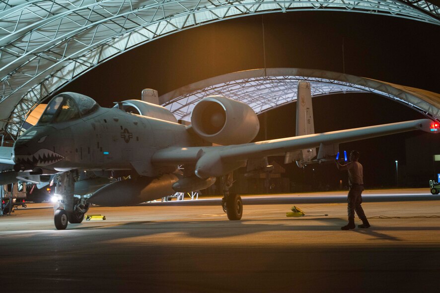 A crew chief from 23d Maintenance Group marshals an A-10C Thunderbolt II for takeoff Sept. 19, 2015, at Moody Air Force Base, Ga. Team Moody deployed A-10s to Amani Air Base, Estonia, as part of a Theater Security Package in support of Operation Atlantic Resolve. TSPs involve the deployment of rotational forces to showcase the Air Force’s ability to rapidly deploy combat air forces. (U.S. Air Force photo by Airman 1st Class Dillian Bamman/Released)