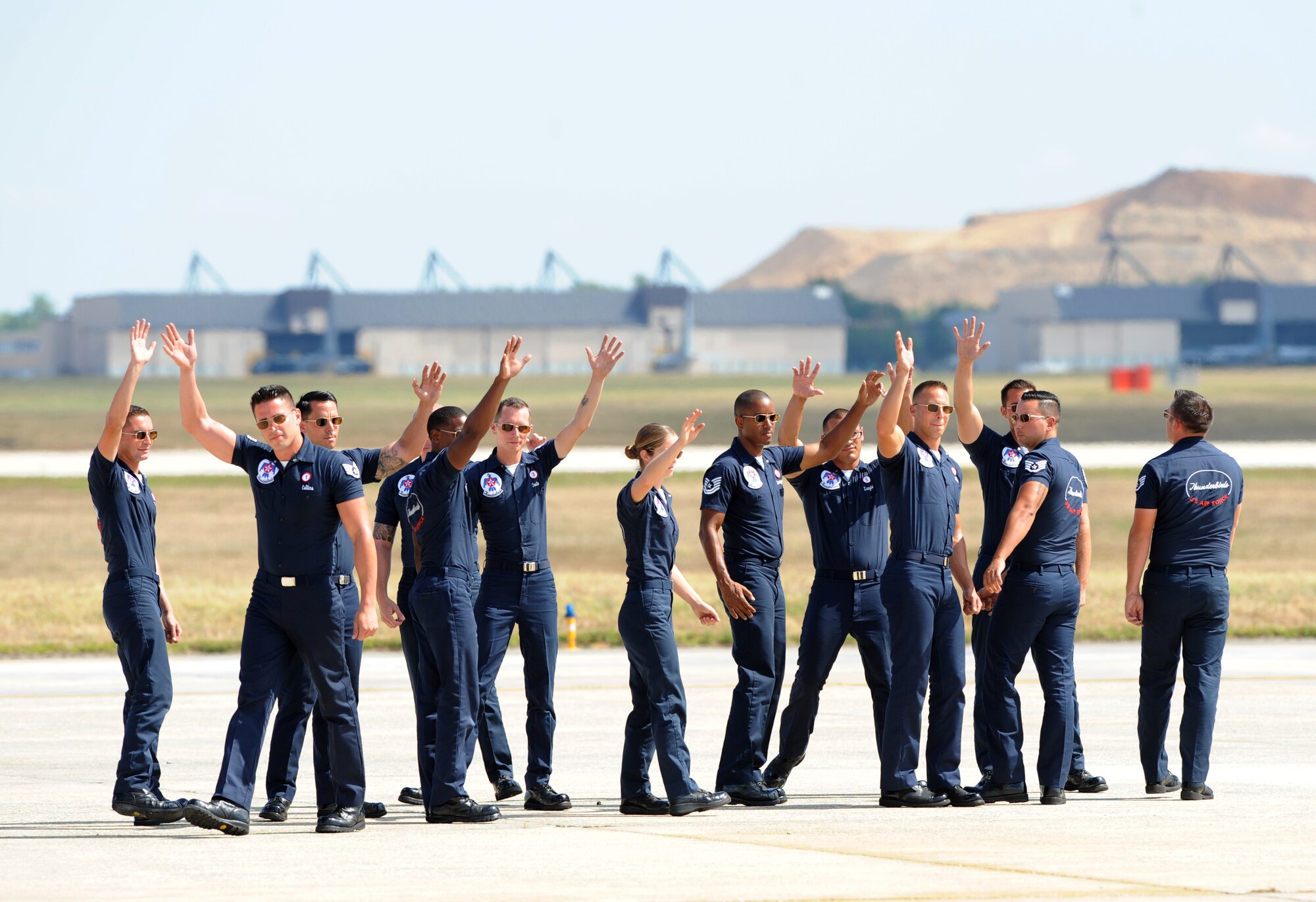 U.S. Air Force Thunderbirds maintenance team waves to the crowd after completing their demonstration during an air show at Joint Base Andrews, Maryland, Sep. 18, 2015. The Thunderbirds serve as the premier air demonstration team for the U.S. Air Force performing around the globe. (U.S. Air Force photo by Senior Airman Bobby Cummings)