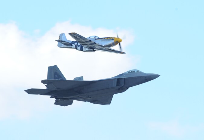 A P-51 Mustang and a F-22 Raptor perform a heritage flight during an air show at Joint Base Andrews, Maryland, Sep. 18, 2015. The P-51 was a vital instrument in obtaining air superiority for allied forces during World War II. (U.S. Air Force photo by Senior Airman Bobby Cummings)