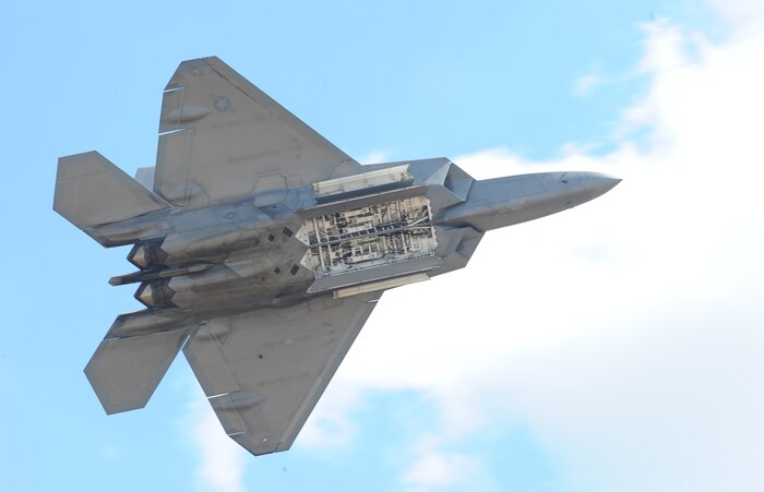An F-22 Raptor reveals its internal weapons bay for spectators during an air show at Joint Base Andrews, Maryland, Sep. 18, 2015. The Raptor performs both air-to-air and air-to-ground missions allowing full realization of operational concepts vital to the 21st century Air Force. (U.S. Air Force photo by Senior Airman Bobby Cummings)