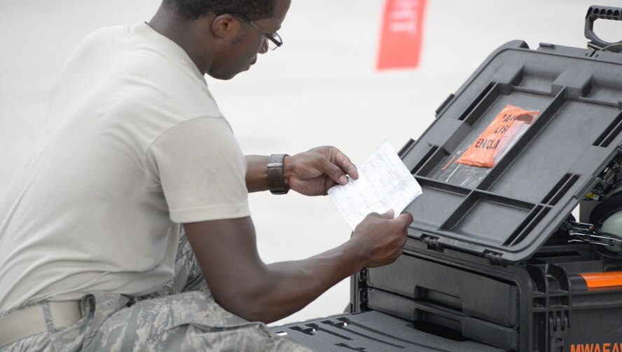 U.S. Air Force Senior Airman Edmund Aldridge, 391st Aircraft Maintenance Unit avionics journeyman reads a piece of paper, July 23, 2015 at Nellis Air Force Base, Nevada. Edmund is one of many avionics technicians' who made sure the jets were operating correctly during Red Flag 15-3. (U.S. Air Force photo by Senior Airman Brittany A. Chase)