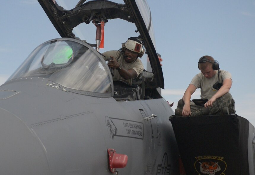 U.S. Air Force Senior Airman Edmund Aldridge, 391st Aircraft Maintenance Unit avionics journeyman points at a part in the F-15E Strike Eagle, July 23, 2015 at Nellis Air Force Base, Nevada. Edmund is one of many avionics technicians' who made sure the jets were operating correctly during Red Flag 15-3. (U.S. Air Force photo by Senior Airman Brittany A. Chase)