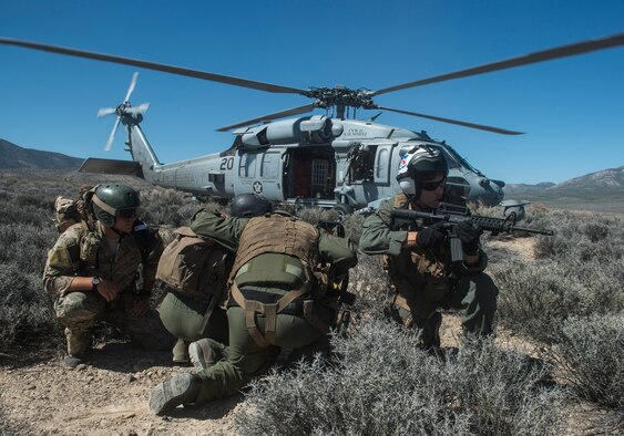 U.S. Air Force Senior Airman Dane Dougherty, 335 Training Group Survival, Evasion, Resistance and Escape specialist and Capt. Jack Green, 480 Fighter Squadron F-16 pilot run to a Sikorsky HH-60 Pave Hawk at the Nevada Test and Training Range, Nevada July 30, 2015. During Red Flag 15-3 the Pave Hawk was used to rescue a simulated downed pilot. (U.S. Air Force photo by Brittany A. Chase)