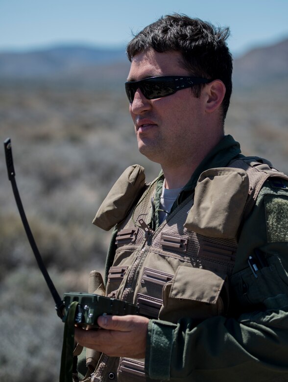 U.S. Air Force Capt. Jack Green, 480 Fighter Squadron F-16 pilot, holds a radio/signal transmitter July 30 at the Nevada Test and Training Range, Nevada. Green, who was simulating a downed pilot during Red Flag 15-3, used various methods to help pilots overhead pin-point his location in order to be saved.  (U.S. Air Force photo by Senior Airman Brittany A. Chase)