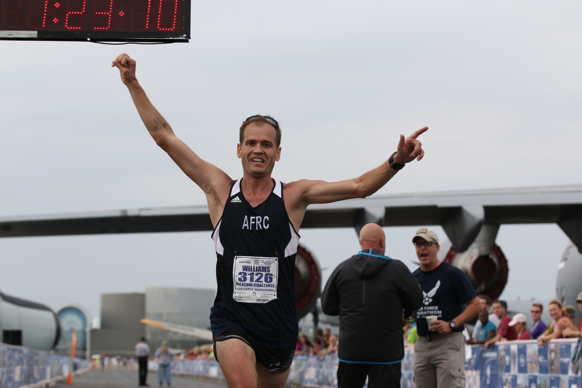 WRIGHT-PATTERSON AIR FORCE BASE, Ohio – Senior Airman Josh Williams, half marathon participant, crosses the finish line in the 19th Annual Air Force Marathon held Sept. 19, 2015. Williams was a member of the Air Force Reserve Command MAJCOM Challenge Team. The team consisted of traditional reservists, air reserve technicians, individual mobilization augmentees and Air Guard Reserve members. The MAJCOM challenge included six Airmen participating in the half marathon and four in the full marathon. (U.S. Air Force photo /Tech. Sgt. Patrick O’Reilly)
