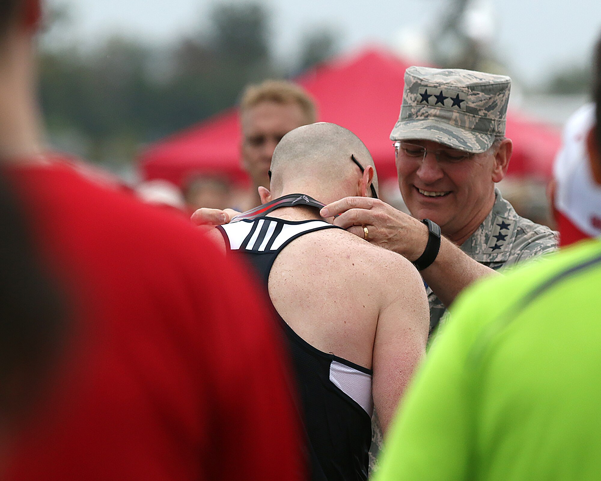 WRIGHT-PATTERSON AIR FORCE BASE, Ohio – Lt. Gen. James F. Jackson, the commander of the AFRC, awards a medal to Technical Sgt. Joel A. Nowatchik, 914th Airlift Wing, Niagara Falls Air Reserve Station, New York, after  he crossed the finish line in the 19th Annual Air Force Marathon held Sept. 19, 2015. Nowatchik  was a member of the Air Force Reserve Command MAJCOM Challenge Team. The team consisted of traditional reservists, air reserve technicians, individual mobilization augmentees and Air Guard Reserve members. The MAJCOM challenge included six Airmen participating in the half marathon and four in the full marathon. (U.S. Air Force photo /Tech. Sgt. Patrick O’Reilly)